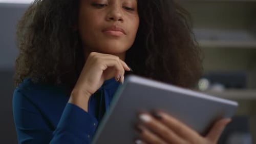 Entrepreneur Woman Using Tablet Device Browsing Information in Modern Office