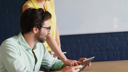 Colleagues Collaborate Using Tablet Technology in the Office