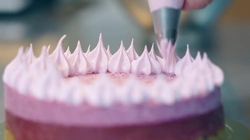 Confectioner Fills Flat Top of Pink Cake with White Cream