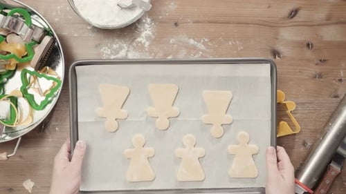 Woman Making Christmas Cookies at Wooden Table