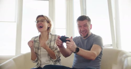 Excited Couple Plays Video Games at Home