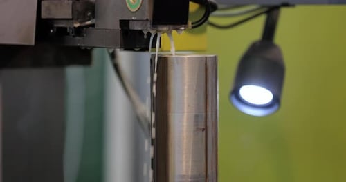 Machine Cutting Metal With Sparks and Water