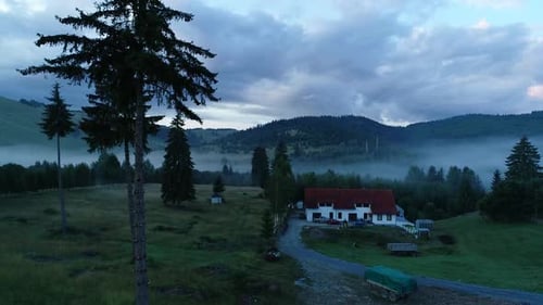 Scenic Aerial View of a Rural House in Mist