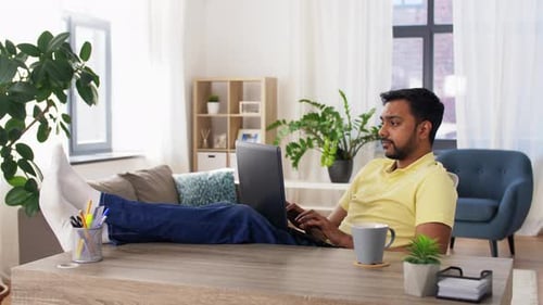 Tired Man with Laptop Working at Home Office