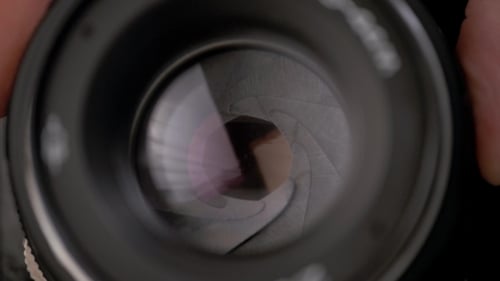 The Diaphragm Of Old Camera Lens Aperture With Warm Light Bokeh