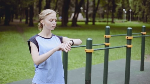 Active Girl Using Fitness Tracker In Sport Playground Touching The Screen Of Smartwatch