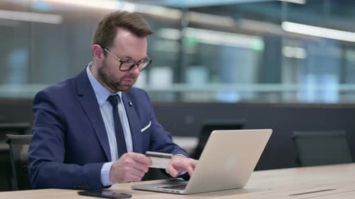 Man in Suit Shopping Online with Laptop