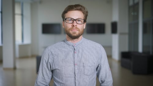 Portrait Of Young Confident Manager In Hall Of Corporation.