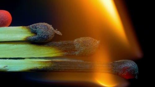 Burning Match Macro on Black Background