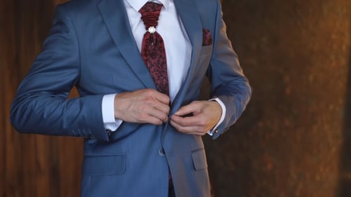 The Groom Buttoning His Jacket