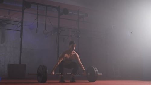 Athlete Raises The Bar With The Weight.