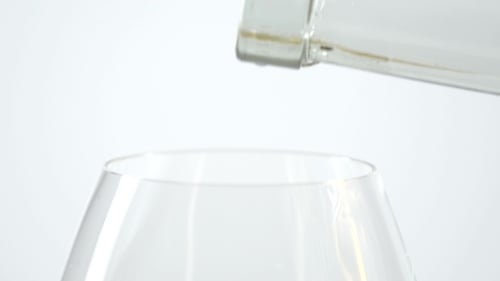 White Wine Being Poured into Glass