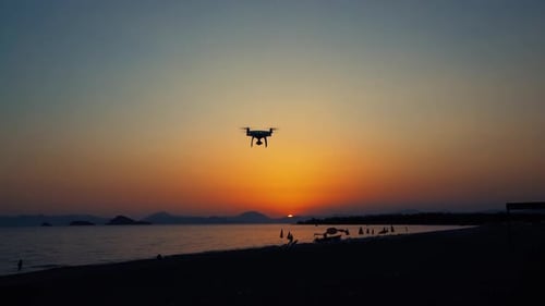 Drone Flying on a Beach at Sunset