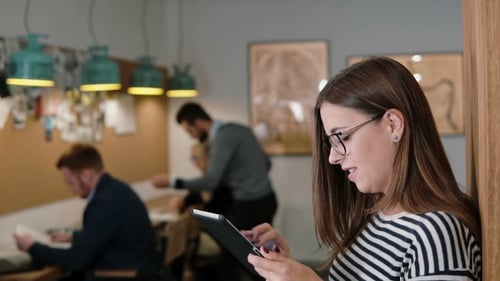 Beautiful Brunette Business Woman Uses Tablet In Modern Startup Office Team In Workplace