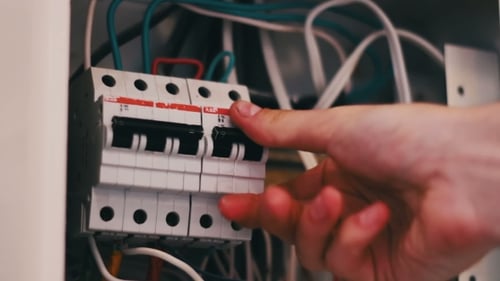 Hand Switches Off Circuit Breaker Close Up