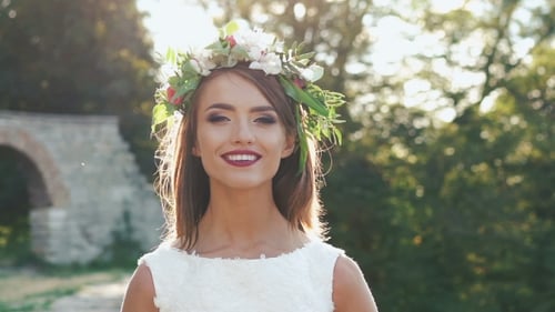 Young Woman Smiling with Flower Crown at Sunset