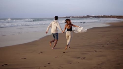 Couple Enjoy Summer Vacation on the Large Beach Enjoy Life and Running in Scenery Slow Motion Video