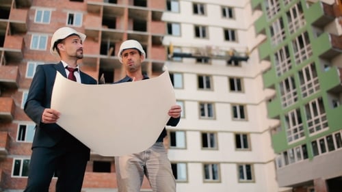 Foremans Looking At The Building Plan