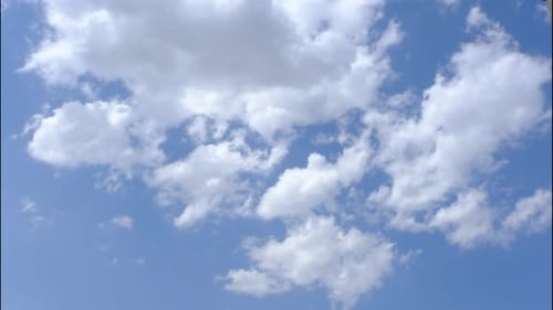 White Clouds Drifting Across Blue Sky