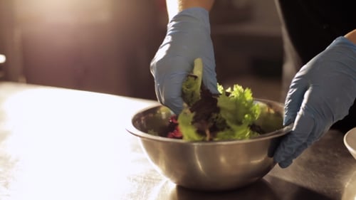 Preparing and Mixing Colorful Salad in Bowl