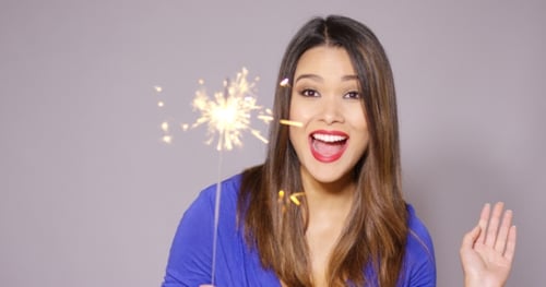 Beautiful Woman Holding a Burning Sparkler