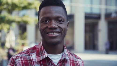 Young Adult Man Smiling in an Urban Setting
