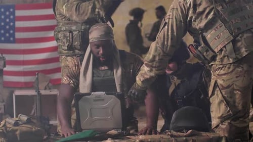 Soldiers Gather in Dimly Lit Urban Command Center