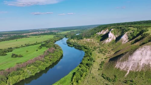 River Flowing Through Rural Landscape Aerial View