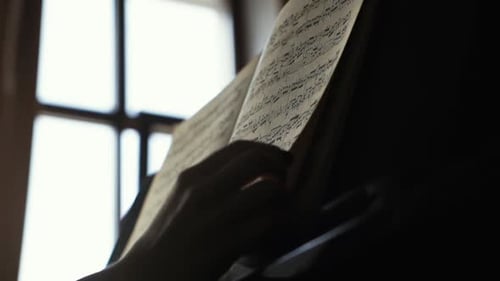 Pianist Girl Leafing Through Musical Notes Close Up in Slow Motion