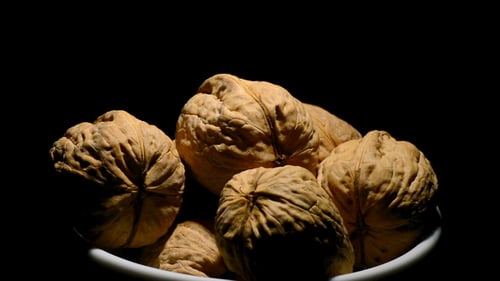 Walnuts in Bowl Close Up on Dark Background