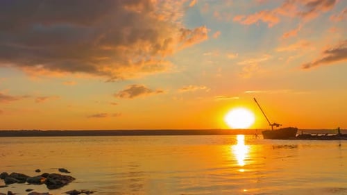 Sunset over the River with Boat in the Background. Time Lapse