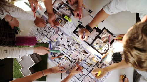 Business, Startup And People Concept - Creative Team With Computers, Blueprint And Scheme At Office