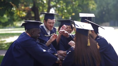 Graduates Cheering After Tossing Caps in Air