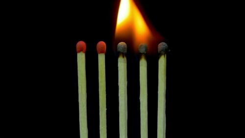 Burning Matches Lighting a Chain Reaction on Black