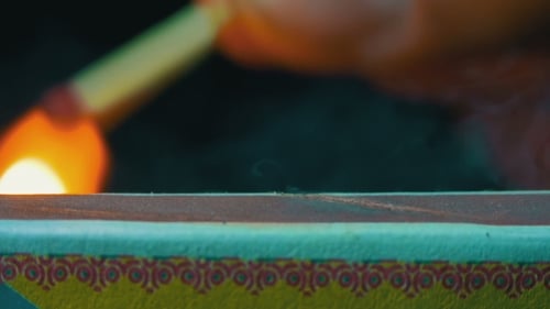 Match Ignites on Colorful Matchbox Side, Extreme Close Up