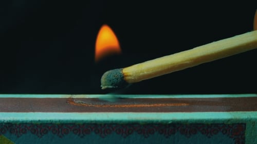 Match Ignites with a Bright Flame on Box