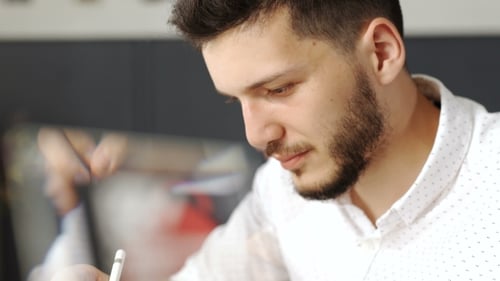 Designer Drawing on Tablet with Stylus in Office