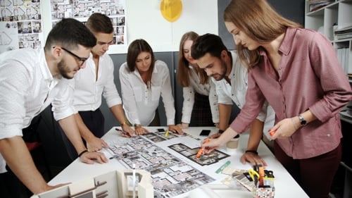 Architects Collaborating on Building Design in Office