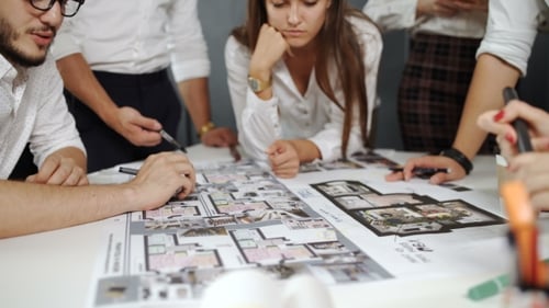 Architects Collaborate on Building Plans at Work