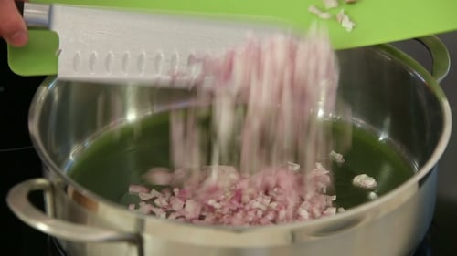 Chef Drops Chopped Onions Into Pan