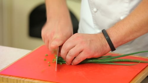 Chopping Green Onions On a Board