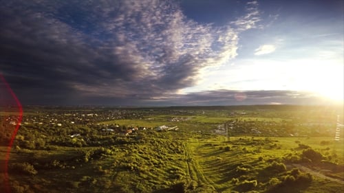 Golden Hour Aerial View of Rolling Green Landscape