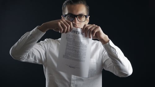 Bespectacled Businessman Tearing a Contract In Pieces