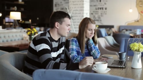 Boy And Girl In Cafe. People Use Laptop And Smartphones, Talk And Drink Coffee.