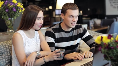 Young Caucasian Couple With Modern Laptop In Cafe