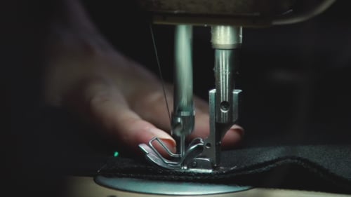 Working Sewing Machine. Manufacturing Equipment At Factory.