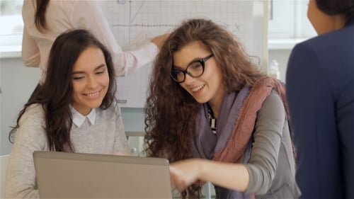 Creative Team Of Four Women Work Actively At The Office