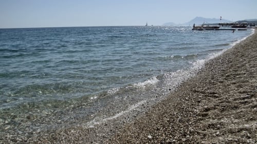 Waves On a Pebble Beach With Reflection Of The Sun In The Waves, Mediterranean Sea