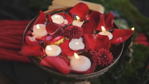 Candles Burn Slowly In a Vase With Rose Petals. Romantic Decor