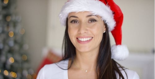 Woman in Santa Hat Smiling at Christmas
